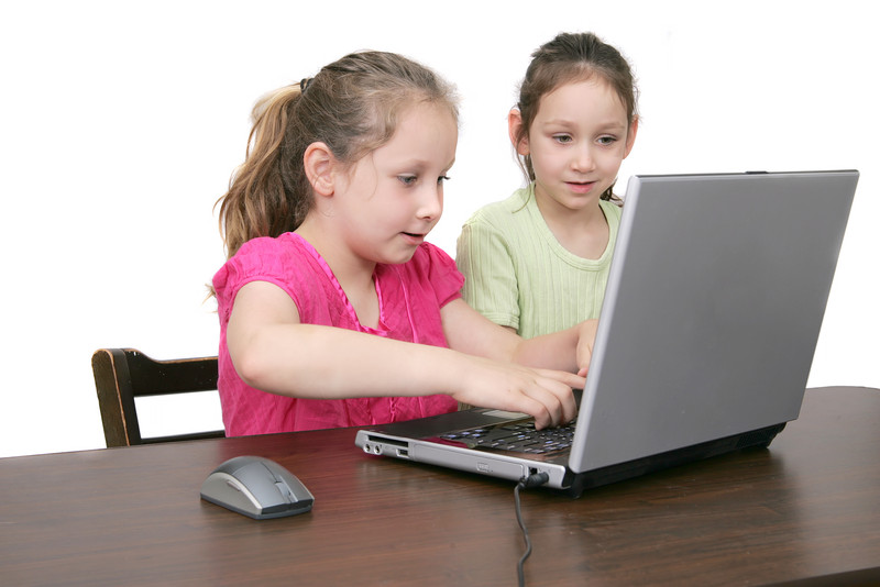 Two girls use a laptop together. Two girls use a laptop together.